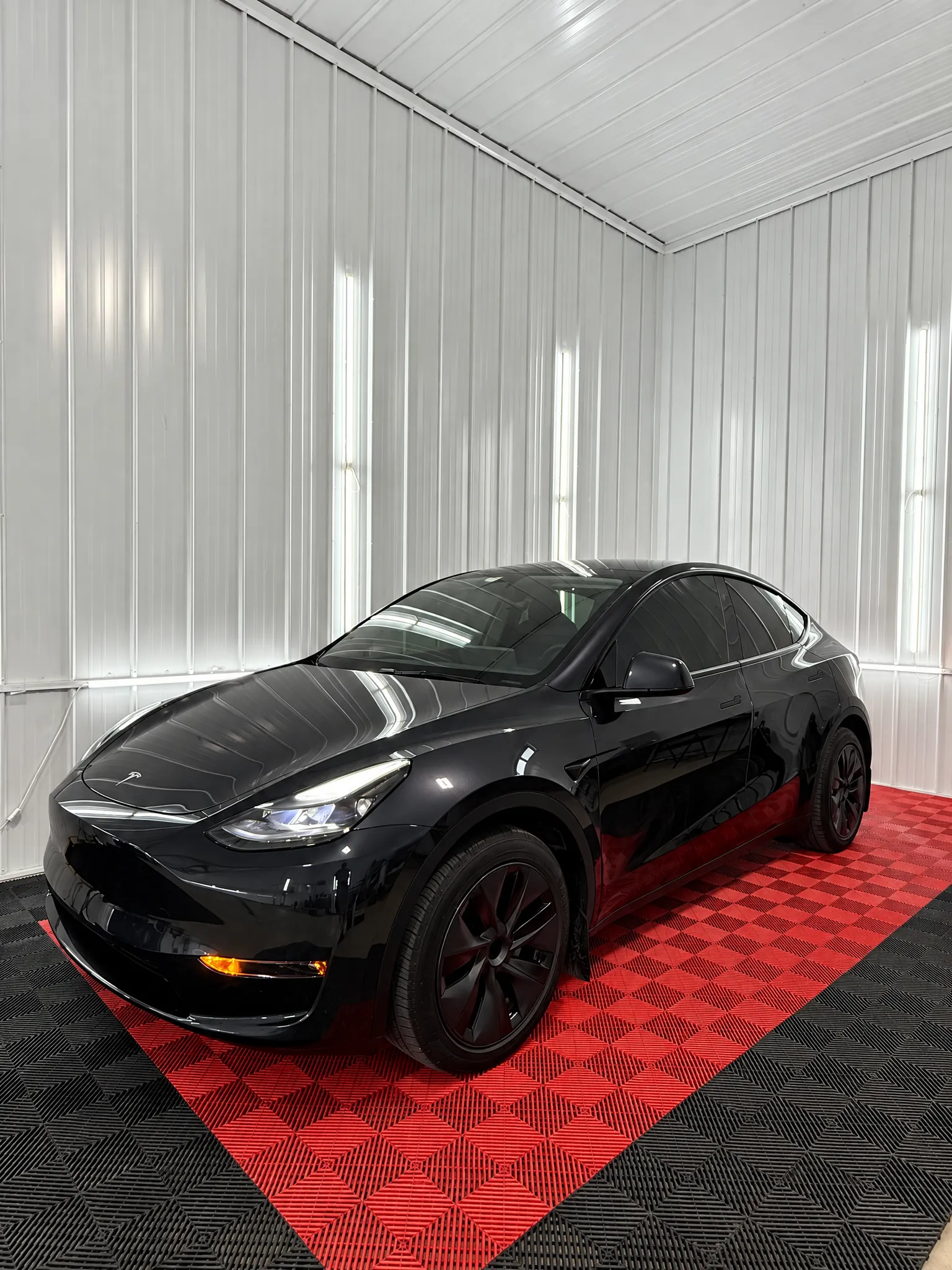 Black Tesla Model Y with tinted windows in the OnPoint Tintz bay